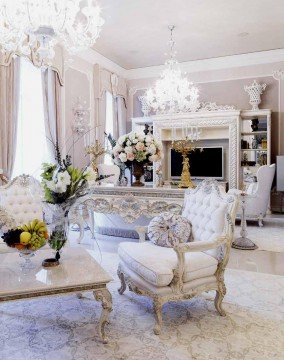 The picture appears to show a large black cat sitting in the middle of a green grassy area. The cat is facing away from the camera and its tail is curled up around its body. The sun is shining brightly behind the cat, illuminating it.