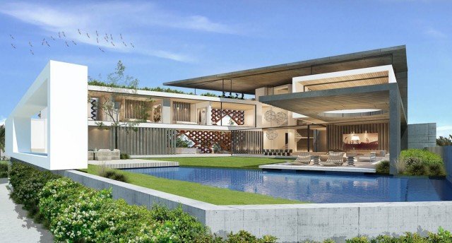 This picture shows a person looking at an IBM server in a data center. The server is lit up with blue lights and consists of several racks of technology components and storage devices. The person appears to be inspecting the server.