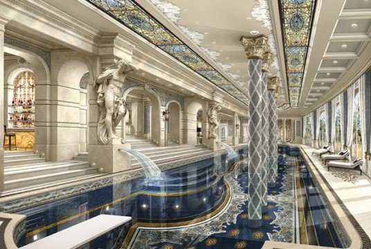 The picture shows an old-fashioned railroad station with a wooden platform, a large building, and a train car. There are several people standing around the platform, waiting for the train. On the left side of the image, a sign reads "Newark Station 1892".