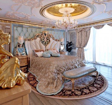 The picture shows a Tyrannosaurus Rex skeleton, surrounded by stone walls. The skeleton appears to have been partially assembled, and its head is pointing up towards the ceiling. The background of the picture is filled with shadows, giving it an ominous feel.