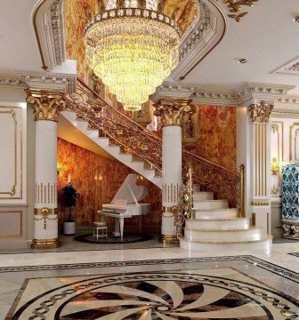 This picture shows a large waterfall in front of a lush green valley, with trees dotting the landscape. The sky is clear and blue, and the sun is shining brightly on the beautiful scene.
