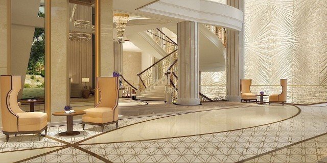 This picture shows a person standing in a grassy field of wildflowers near the ocean. The person is wearing a blue shirt and shorts, and holding a white parasol in one hand. The horizon stretches out in the background, and there are several wispy clouds drifting across the sky.