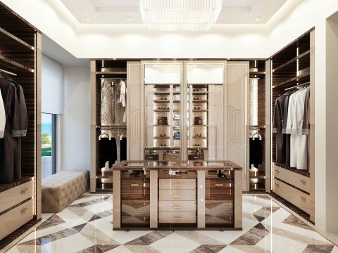 This picture shows a small group of children and adults gathered in a room surrounded by books. The adults appear to be enjoying story time with the children, with one of the adults pointing to a book as the children watch intently.