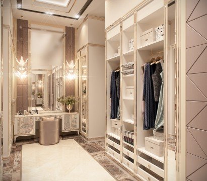 This picture shows a person sitting on a rock surrounded by trees and a lake. The person is wearing a red shirt and blue jeans and is looking off into the distance as if deep in thought. The lake is partially obscured by trees, but the reflections of the trees can be seen in the water.