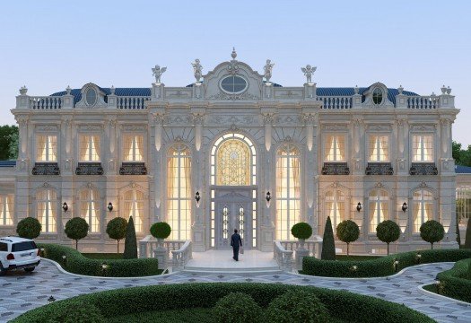 This picture shows a yellow Volkswagen Beetle parked in front of a white picket fence with a beach in the background. The car is parked on an asphalt road, and there is a tree visible to the right of the car. The sky is a hazy blue.