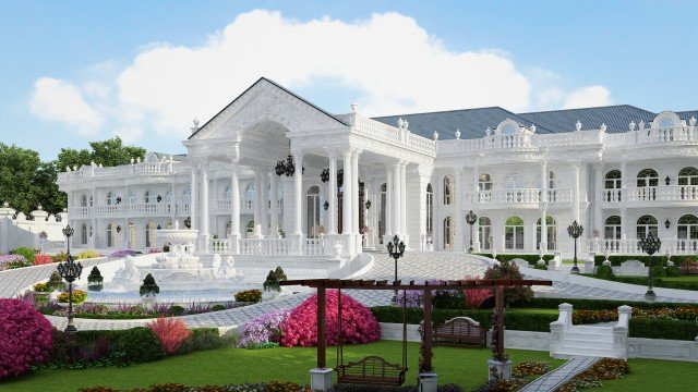 This picture appears to be a modern, luxurious living room space. The room is decorated with a beautiful, dark wood floor and white furniture. There are two large, matching sofas in the center of the room, with two bright patterned pillows in the center of each sofa. The walls are painted in a light grey shade, and several pieces of art are hung on the walls. Light fixtures hang from the ceiling, providing a warm glow to the room.
