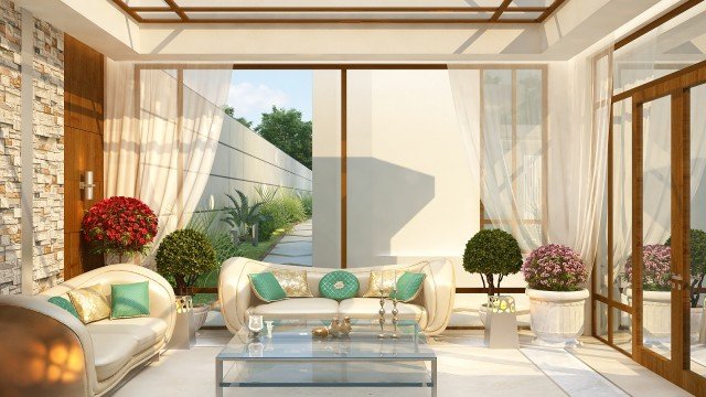 This picture shows an ornate, luxurious living room furnished with a grand piano, crystal chandelier, and expensive artwork. The walls are painted in a bold yellow hue and feature elaborate moldings. The cream-colored furniture is upholstered in silk fabric and the floor is covered in a large Persian rug.