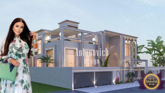 This picture shows a modern minimalist living room designed by Antonovich Design. It features two royal blue velvet armchairs and a matching ottoman, which are positioned in front of a marble fireplace with a flat-screen television mounted above it. The neutral walls and ceilings create a sense of spaciousness, and the combination of different textures, including metal and wood, create a luxurious yet cozy atmosphere.