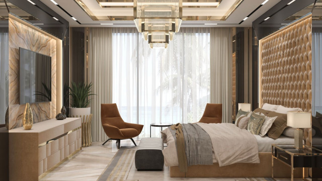 This picture shows an ultra-modern luxury kitchen with stainless steel appliances and cabinets. The walls are a pale shade of blue, and the countertops are a sleek, white stone. There is a large island in the center of the room with contemporary stools, and an oversized white pendant light hangs from the ceiling.