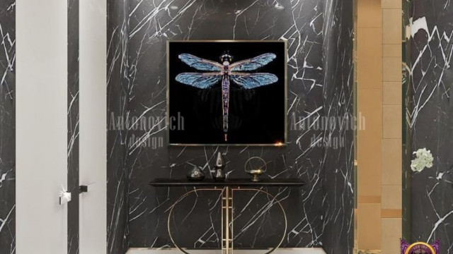 This picture shows a modern white living room with a sectional sofa, a glass coffee table, and an abstract painting on the wall. The furniture is arranged to create a spacious and inviting atmosphere. The light grey walls and white trim create an airy and minimalist feel. There are large windows that allow natural light to fill the space, as well as recessed lighting for additional illumination.