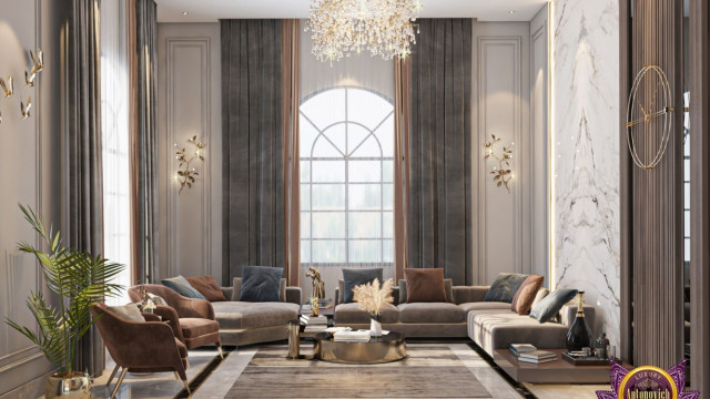 This picture shows a large, modern living room with white walls, light wood floors, and an impressive custom-built ceiling with intricate patterns. The furniture is designed in a modern style, with clean lines, off-white sofas, and contemporary armchairs in bright colors. The large windows and glass doors provide plenty of natural light and offer a relaxing outdoor view. The room is decorated with a few abstract art pieces and a bright yellow accent wall, which adds an interesting color contrast.