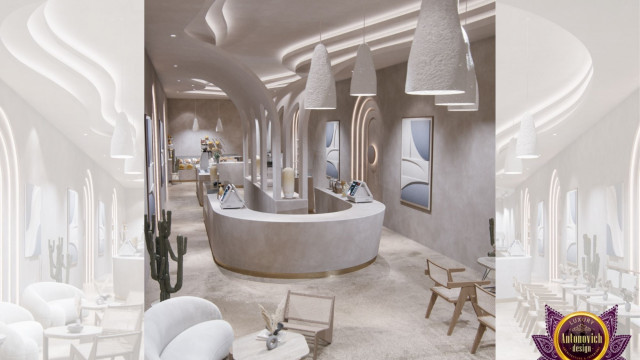 This picture is of a modern kitchen, featuring a large island with a white marble countertop and integrated seating. The kitchen also includes stainless steel appliances and cabinetry, as well as plenty of storage space. A large window behind the island allows natural light to pour in, illuminating the open space.