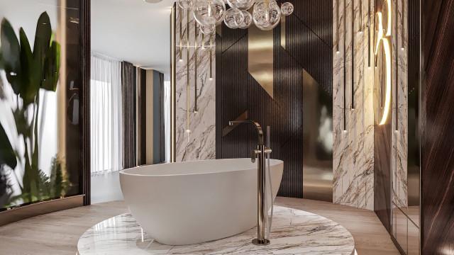 The picture shows a well-designed, modern living room. The walls are painted dark blue and feature a white accent wall with a built-in shelf and TV. The ceiling is painted white and has two modern, square-shaped light fixtures. The furniture consists of a grey couch, matching armchair, and two small side tables. The floor is covered with a light grey carpet and there is a large abstract painting hung above the couch.