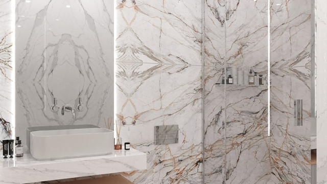 This picture shows an elegant, luxurious living room with a stunning view of a city skyline. The room is decorated in shades of white and cream, with a classic crystal chandelier balancing the modern abstract painting on the wall. The furniture is upholstered in white velvet, with tufted cushions, and the fireplace is framed by a golden-white marble mantelpiece. The carpet is a soft beige with detailed patterns, and tall windows allow the light from outside to flood the room.