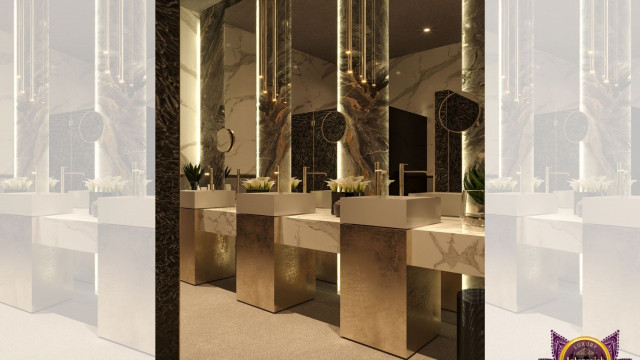 This picture shows a luxurious living room interior designed by Antonovich Design. The room features an ornate light gray sofa paired with two armchairs and a coffee table. Additionally, there is an imposing marble fireplace, ornate rug and a large flat-screen TV. An eye-catching chandelier hangs from the ceiling, and the elements are framed by intricate wall designs and white crown molding.