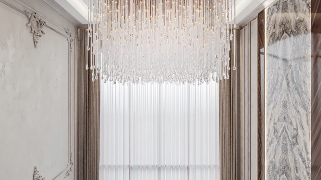 A luxury master bedroom featuring a wooden canopy bed with a chaise longue, a long dressing table, and a large mirror.