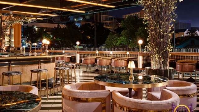 Traditional-style interior featuring a blue velvet sofa and large ornate chandelier.