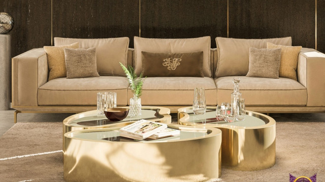 Vibrant cream bedroom featuring a canopy bed, chaise longue, ornate wall accents, and large bay windows with white drapes.