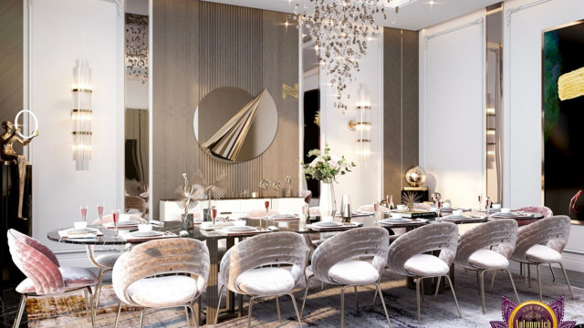 This picture is a modern-style lounge area with a curved white sofa, two matching armchairs, and a glass and metal end table. The sofa and armchairs are upholstered in a light gray fabric, and there is a black-and-white patterned rug in the center of the space. The walls are painted a bold shade of blue and there are several framed art pieces on the walls. In the corner of the room is a fan-shaped standing lamp, providing additional light sources.