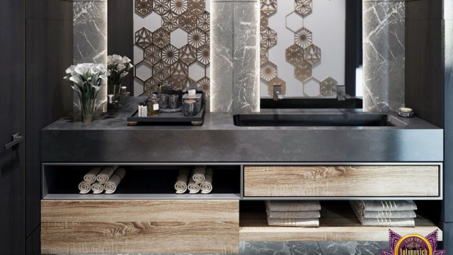 The picture is of a luxurious living room that features a large seating area with two matching sofas and four large armchairs. The furniture is arranged in a cozy conversational setting, with a round coffee table in the center and an ornate rug draped across the floor. The walls are painted a warm golden color, and the room is lit with several elegant, crystal chandeliers. A grand piano is also visible in the corner of the room.