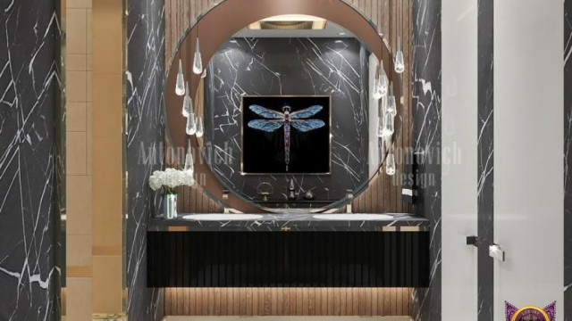 A large white kitchen with light brown cabinets, a breakfast bar, and modern appliances.