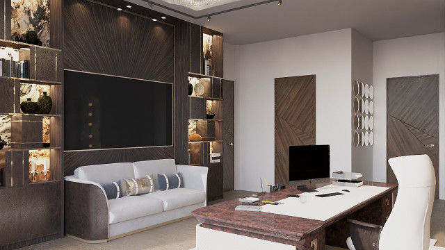 This picture shows a luxurious home interior with several elegant and sophisticated elements. There is a large white marble staircase, with intricately detailed railings and balustrades. The walls are covered in light beige wallpaper, while the floor is lined with an ornate beige carpet. On the right side of the room, there is an elaborate chandelier hanging from the ceiling. To the left, there is a luxurious sofa with patterned pillows and an armchair, both upholstered in a gray-blue fabric. In front of these furnishings, there is a