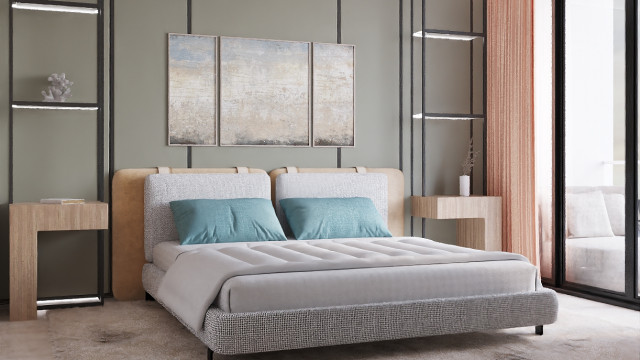 In this picture, a modern living room is shown with two white armchairs facing each other with a black and white coffee table in between them. The walls are light grey and the floor is covered with a white and grey rug. A large painting or tapestry hangs on the wall, adding a pop of color to the room. The furniture is sleek and modern and the overall look is calming and inviting.