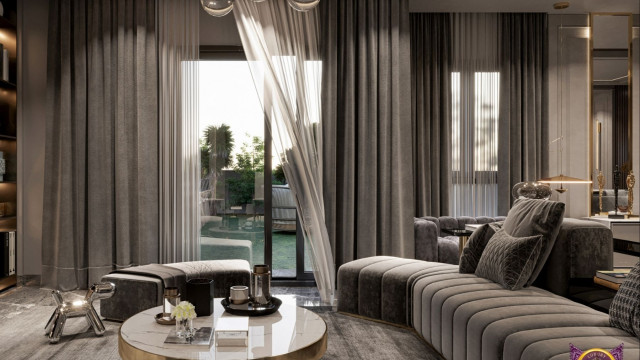 This picture is of an elegantly designed dining room featuring an ornately detailed ceiling, luxurious window treatments, beautiful chandelier lighting, and a dramatic table setting for a formal dinner. The walls are covered in a light beige fabric with subtle striped accents, while the furniture is classic and traditional in style, with lush upholstery in shades of creamy white and light espresso brown.