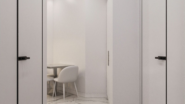 A modern, minimalist living room designed in light and neutral colors and featuring a plush, white seating area.