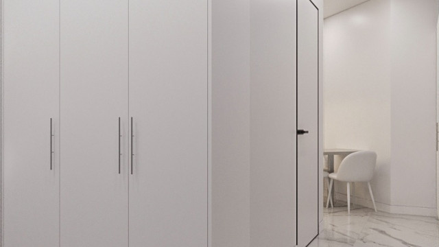 Luxurious open space featuring modern interior design with a grand double staircase, white accents, and ornate chandelier.