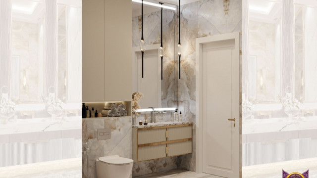 This picture is showing an elegant, beige-toned room with many luxurious features. There is a large stone fireplace, a large chandelier with matching wall sconces, and a plush beige sofa with white pillows. The walls have intricate patterned wallpaper and the ceiling has a light-colored trim. There are several pieces of bold artwork hanging on the walls, as well as shelves and other decorative items. In the center of the room there is a cozy seating area with an ornate coffee table.