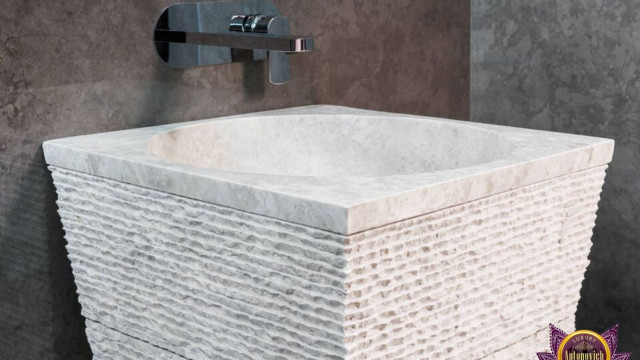 This picture shows a modern-style office with a luxurious marble floor, a large desk with a custom-made chair, and a curved sofa in the center of the room. The walls are painted a crisp white, while the ceiling has an intricate wood paneling. There is also a decorative light fixture hanging from the ceiling, giving the space a sense of sophistication and elegance.