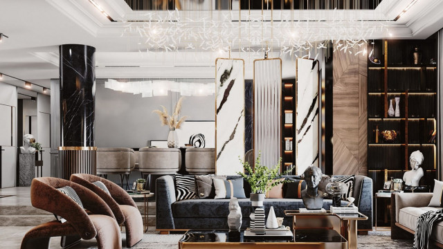 This picture shows an outdoor living space with an outdoor dining area and seating area. The outdoor furniture is arranged around a modern fire pit that has a concrete base and metal surround. There is a sectional sofa with green cushions and a coffee table, along with several chairs surrounding the fire pit. A large umbrella provides shade in the background, and the entire space is decorated with plants and other natural elements.