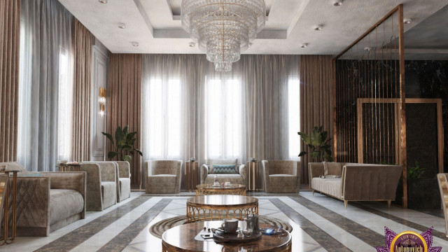 A white and gold vestibule with a grand, curved staircase and a stained glass window at the top of the stairs.