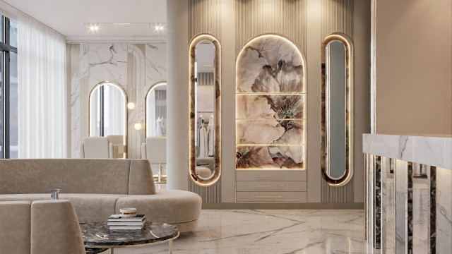 This picture shows an elaborate and luxurious foyer designed by Antonovich Design. It features a grand, spiral staircase with a curved railing and elegant black marble floors. On the walls are large abstract paintings and there are two marble-topped tables with intricate patterns on them. The ceiling is adorned with crystal chandeliers and high ceilings with intricate detailing on the walls.