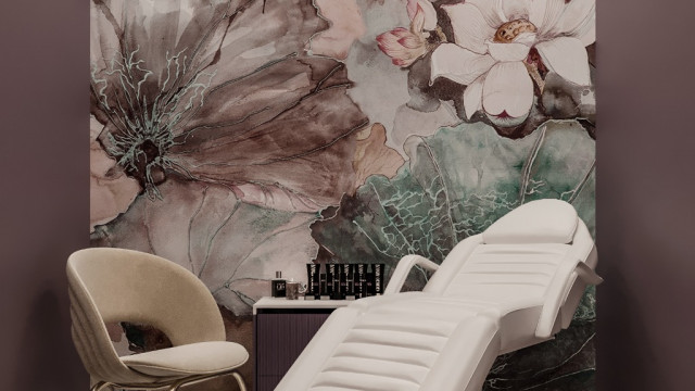 A modern kitchen with a white marble countertop, light-colored cabinets and stainless steel appliances.