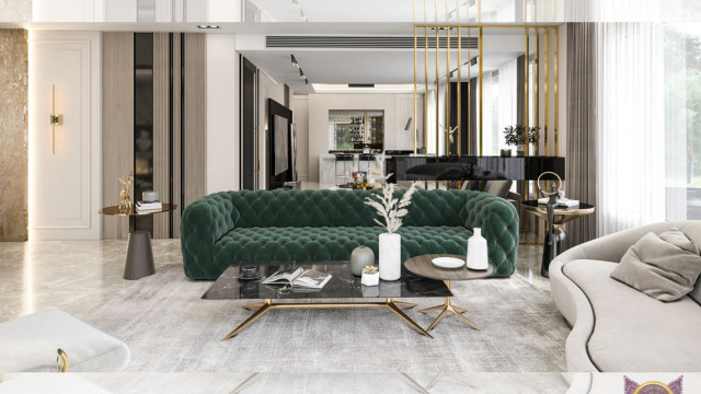 This picture shows a modern style living room. The room has an open floor plan and utilizes neutral colors throughout, such as white walls with accents of light gray, brown and beige. There is a cozy seating area featuring a sectional sofa, a large armchair and a glass coffee table. A decorative area rug lies beneath the seating area and ties together the space. On the opposite side of the room from the seating area is an entertainment center with a wall mounted flat screen television and shelves for storing books, magazines and other items.