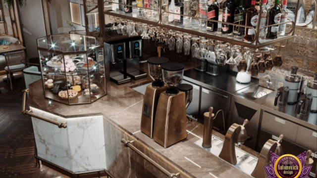This picture shows a modern, luxury living room designed by Antonovich Design. The room has a white marble floor, with a brown leather sofa to the left and a small glass coffee table in front of it. The walls are painted a light gray color and have several framed art pieces hanging from them. In the center of the room is a white chandelier that hangs down from the high ceiling. There are also two gray armchairs to the right of the sofa and a white mantel with a small fire burning inside.