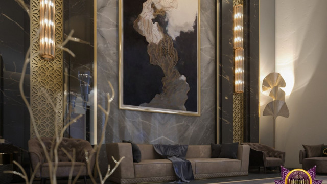 This image shows a modern living room designed by Antonovich Design. It features a curved white sofa, surrounded by modern decor and accents including a white ottoman, a black and white area rug, a yellow side table, and several abstract art pieces. The walls are painted a light cream color, while the ceiling is fitted with warm-toned recessed lighting.