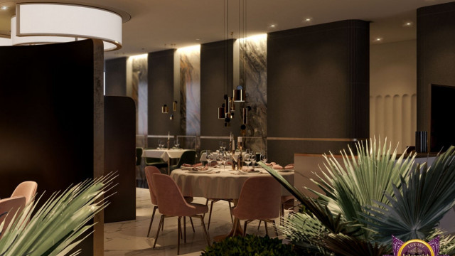 The picture depicts a modern, two-story private residence with white walls and dark accents on the roof and window frames. The building features a curved staircase leading up to the second floor, accented by a balcony overlooking the main entrance.