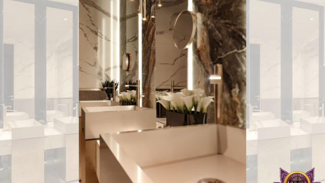 This picture is of a modern living room with a contemporary design. The room features various shades of grey and white, including light grey sofas, dark grey decor pieces and a white fireplace. The walls are painted a light grey hue and have an abstract art piece hung above the fireplace. The flooring is a light hardwood, and there is a small rug in the middle of the room for added comfort. The large window on one side allows natural light to enter the room, making it bright and airy.