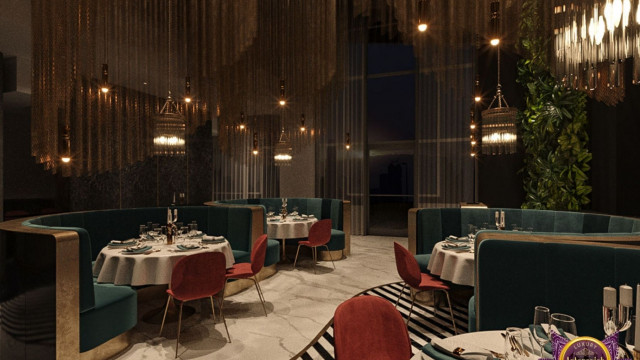 A contemporary interior with a curved seating area, fully upholstered in a luxurious white material with grey geometric arm rests and an ornate patterned throw pillow.