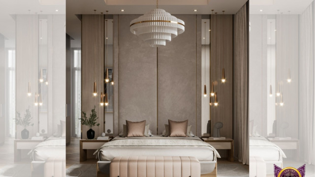 This picture shows an open-concept modern kitchen. It features a glossy white countertop with a built-in cooktop and oven, as well as stainless steel appliances. There is a large island in the center of the room with a sink and breakfast bar. The walls are painted in a light gray color, and there are wood cabinets and drawers along one wall. A light fixture hangs from the ceiling, providing extra lighting.