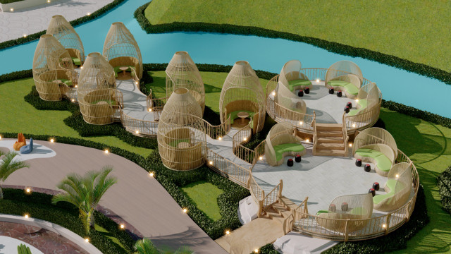 This photograph shows an ornate design of a ceiling in an interior space. The white and gold ceiling features intricately carved wood details that are accentuated by intricate gold leaf gilding around the edges of the panels and in the center of the ceiling. The design is composed of several symmetrical geometric shapes, including circles, diamonds, and squares. There is an ornamental chandelier hanging from the center of the ceiling and light fixtures along the sides.