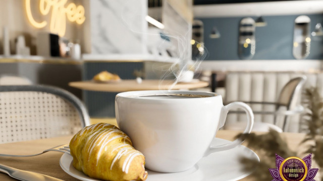 This picture depicts an ultra-modern living room featuring a velvet sectional sofa and contemporary armchair in soft shades combined with luxury black and white accents. The floor is finished with dark wood, and there is a modern fireplace along one wall. A large round rug with a geometric pattern lies in the center of the room, adding a pop of color and texture. The walls are painted in a light gray color and adorned with abstract artwork.