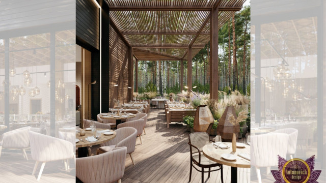 This picture shows a luxurious interior home design with modern and traditional elements. There is an impressive grand staircase leading to the second floor, with a beautiful crystal chandelier hanging from the ceiling above. The walls are painted in a muted gray color and detailed with white crown molding. The floor is covered in a light gray carpet, and to one side of the staircase is a large black marble fireplace flanked with two stylish chairs.