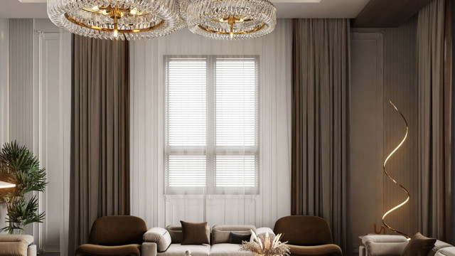 Luxurious living space featuring white velvet couches, two marble coffee tables, and an artistic wall display of photographs.