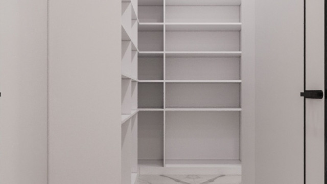 This picture shows a peek inside an elegantly designed living room. The floor is covered in a light-colored hardwood, and the walls are painted a pale off-white color. There is a fireplace on one wall with a decorative mantel, and on the floor in front of it sits a white sofa with gold accents. On either side of the fireplace are large windows with gauzy white curtains, letting in lots of natural light. In the corner of the room is a tall potted plant, and the space is completed by several small area rugs.