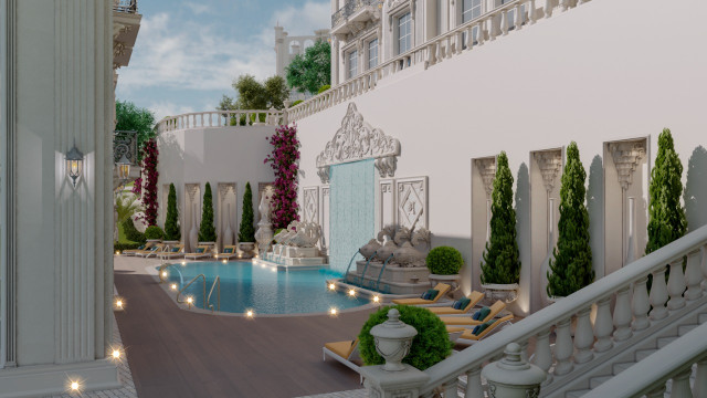 This picture shows a minimalist living room with light grey walls, a white sofa and armchair, and a modern black and white rug. The room also features a dark wooden floor, an abstract art piece, and a black and white framed mirror on one wall. There are also several potted plants adding pops of color and texture throughout.