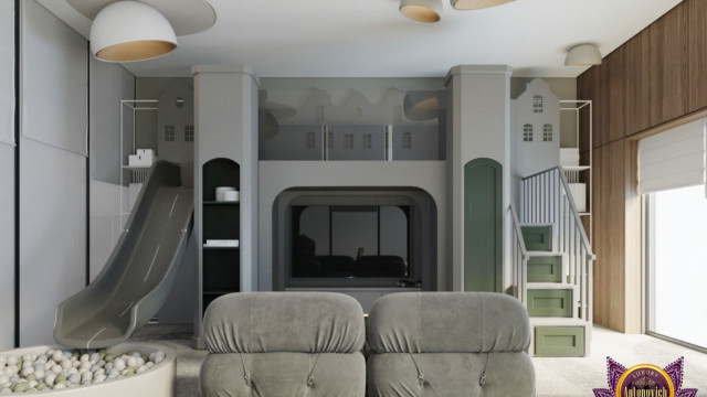 This picture shows in a modern, luxurious home kitchen. The kitchen features a large center island with marble countertop and stainless steel sink, as well as a wall of cabinets with granite countertops. The backsplash is white subway tile and the kitchen has recessed lighting throughout. The walls are painted light gray and the floors are white porcelain tile.